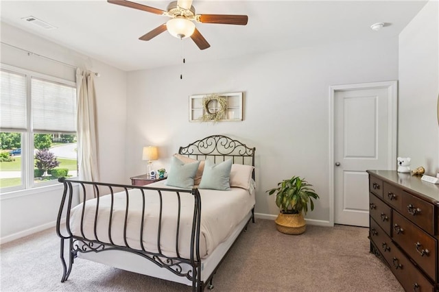 4972 Park Vale Dr, Sugar Hill, GA 30518 - bedroom featuring multiple windows, light carpet, and a ceiling fan