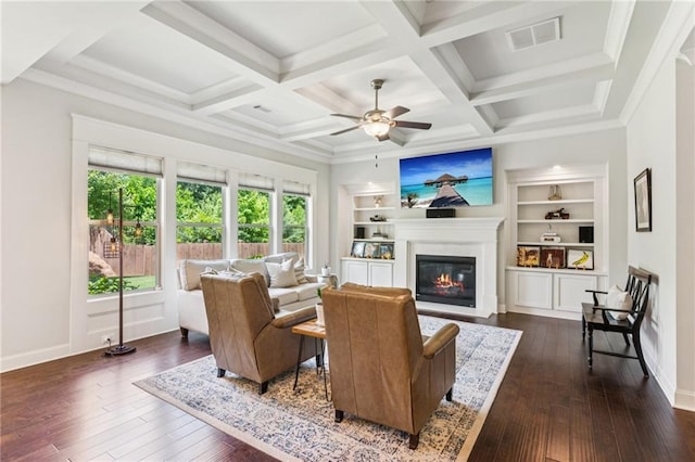 4972 Park Vale Dr, Sugar Hill, GA 30518 - living room featuring a glass covered fireplace, dark wood-style floors, ceiling fan, beamed ceiling, and built in features