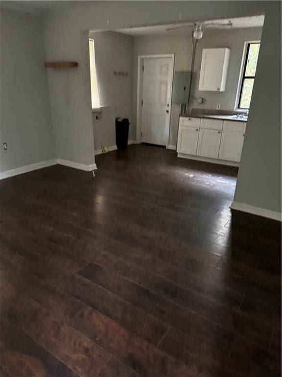 kitchen featuring dark wood-type flooring and white cabinetry