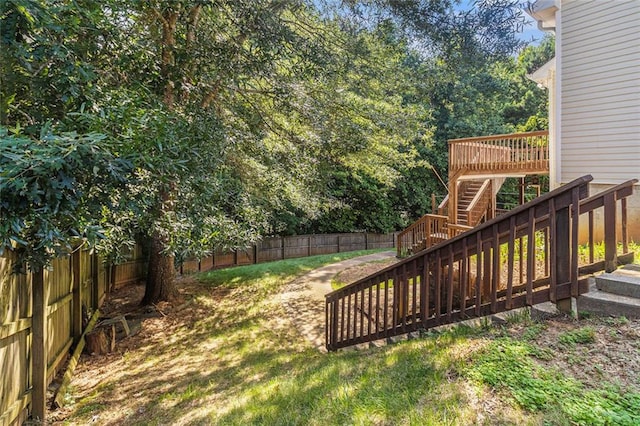 6411 Compass Dr, Flowery Branch, GA 30542 - fenced backyard featuring stairs and a wooden deck