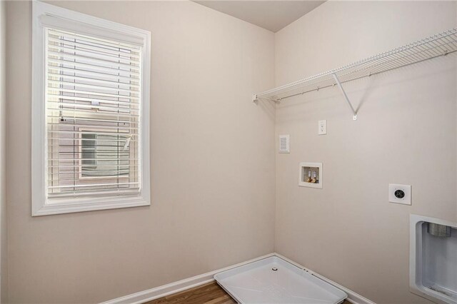 laundry area with laundry area, baseboards, wood finished floors, hookup for a washing machine, and hookup for an electric dryer