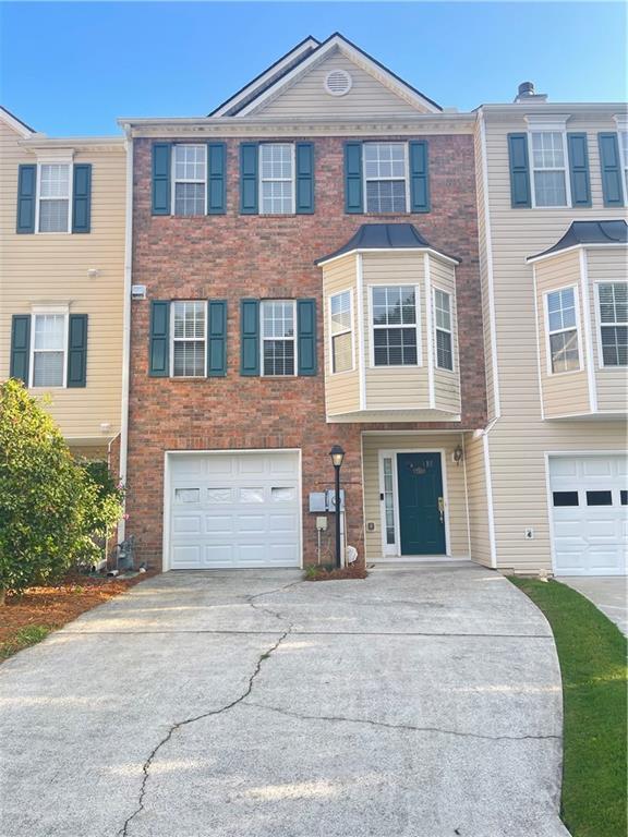 795 Abbotts Mill Ct Unit 73, Johns Creek, GA 30097 - multi unit property featuring a garage, driveway, and brick siding