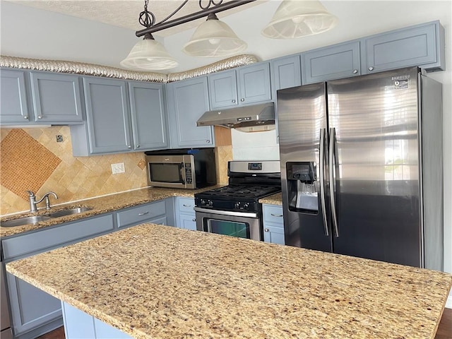 795 Abbotts Mill Ct Unit 73, Johns Creek, GA 30097 - kitchen featuring appliances with stainless steel finishes, under cabinet range hood, light stone counters, tasteful backsplash, and blue cabinetry