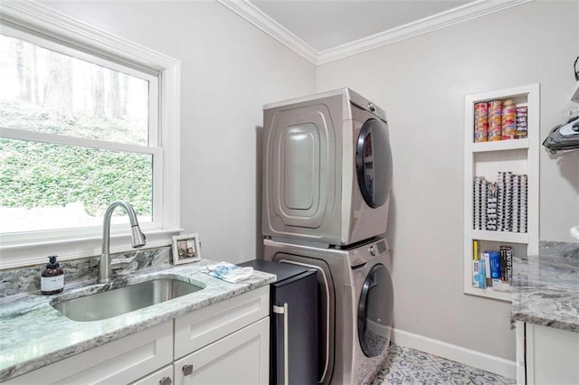 washroom featuring stacked washer / drying machine, crown molding, sink, cabinets, and light tile patterned floors