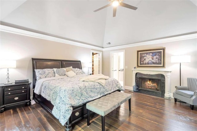 bedroom with a fireplace, dark wood-type flooring, ceiling fan, and high vaulted ceiling