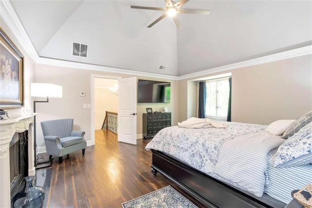 bedroom featuring ceiling fan, dark hardwood / wood-style floors, a premium fireplace, high vaulted ceiling, and ornamental molding