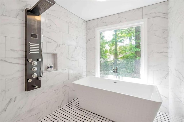 bathroom with tile patterned floors, tile walls, and a bath