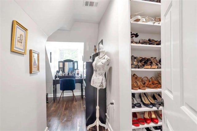 interior space with built in shelves and dark hardwood / wood-style floors