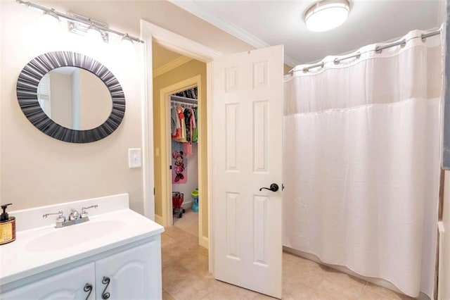 bathroom with tile patterned floors, vanity, and ornamental molding