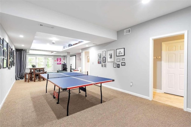 playroom with carpet flooring and a raised ceiling