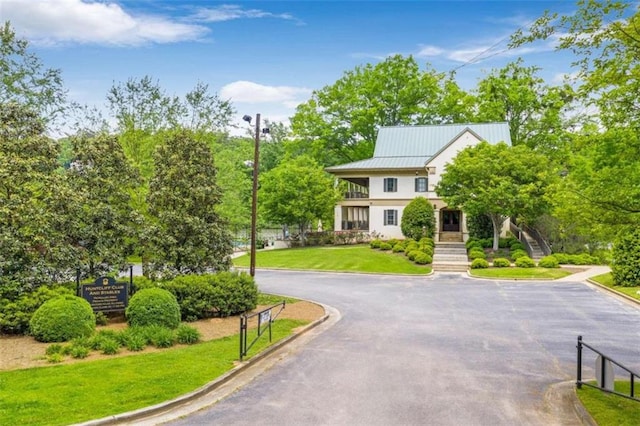 view of property's community with a lawn