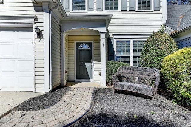 view of exterior entry featuring an attached garage