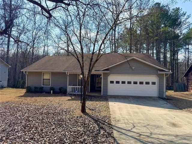 single story home featuring a garage, covered porch, and concrete driveway