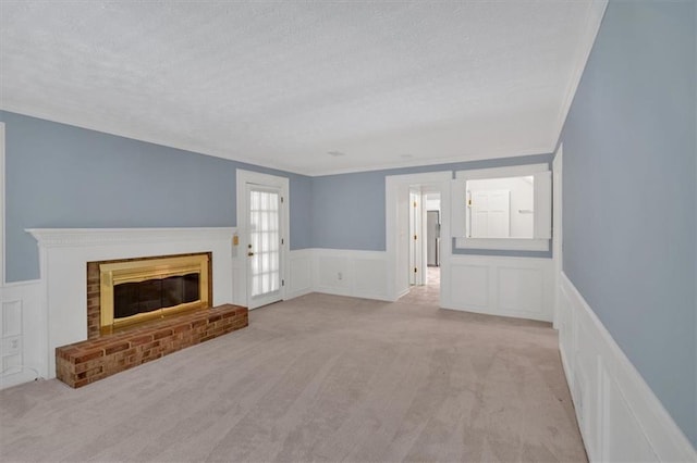 4181 Singing Post Ln NE, Roswell, GA 30075 - unfurnished living room featuring a textured ceiling, a decorative wall, a wainscoted wall, light carpet, and a brick fireplace