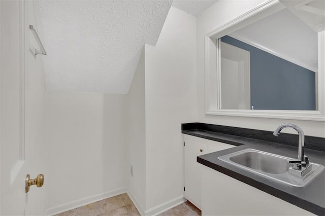4181 Singing Post Ln NE, Roswell, GA 30075 - bar with a sink, a textured ceiling, baseboards, and lofted ceiling