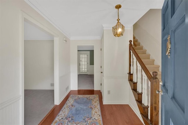 4181 Singing Post Ln NE, Roswell, GA 30075 - entrance foyer featuring stairway, wood finished floors, crown molding, a decorative wall, and wainscoting