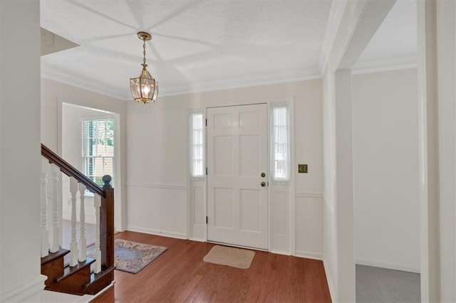 4181 Singing Post Ln NE, Roswell, GA 30075 - foyer with wood finished floors, crown molding, stairway, a chandelier, and wainscoting