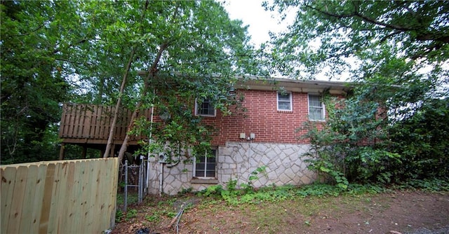 1398 Christmas Ln NE, Atlanta, GA 30329 - view of home's exterior with stone siding, a deck, and brick siding