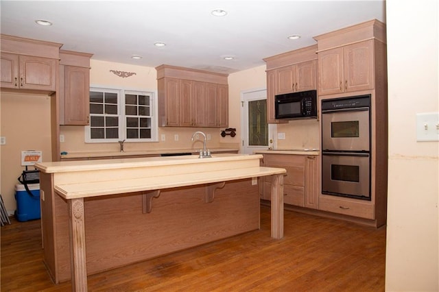 1398 Christmas Ln NE, Atlanta, GA 30329 - kitchen featuring black microwave, a sink, double oven, light brown cabinets, and light countertops