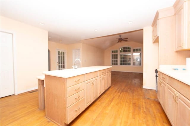 1398 Christmas Ln NE, Atlanta, GA 30329 - kitchen featuring light brown cabinets, ceiling fan, light countertops, light wood-type flooring, and vaulted ceiling