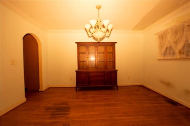 1398 Christmas Ln NE, Atlanta, GA 30329 - unfurnished room featuring arched walkways, a chandelier, wood finished floors, crown molding, and baseboards