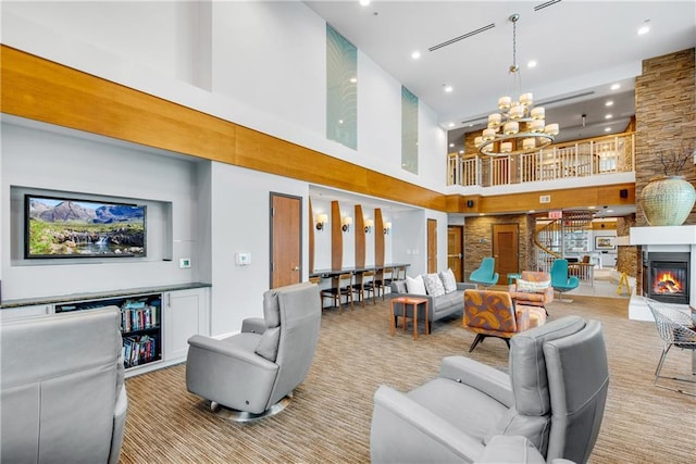 living room featuring a towering ceiling and a chandelier