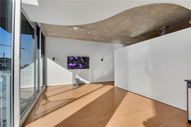 living room featuring wood-type flooring and a wall of windows