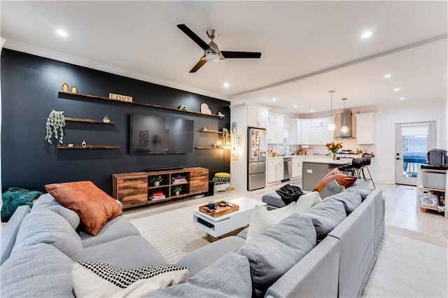 living room featuring ceiling fan and light hardwood / wood-style floors