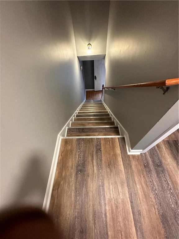 stairway with hardwood / wood-style flooring