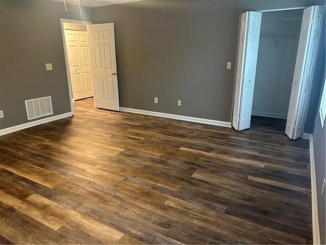 unfurnished room featuring dark hardwood / wood-style flooring