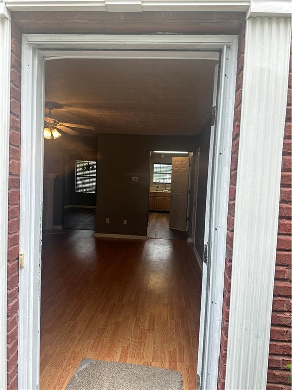 spare room with dark hardwood / wood-style flooring, a textured ceiling, and ceiling fan