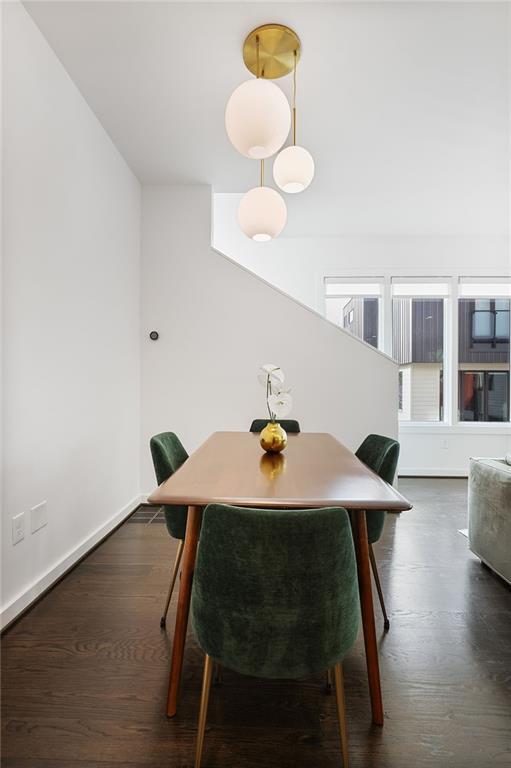 dining room with dark wood finished floors and baseboards