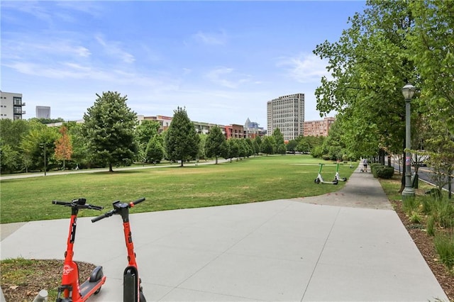 view of home's community with a view of city and a lawn