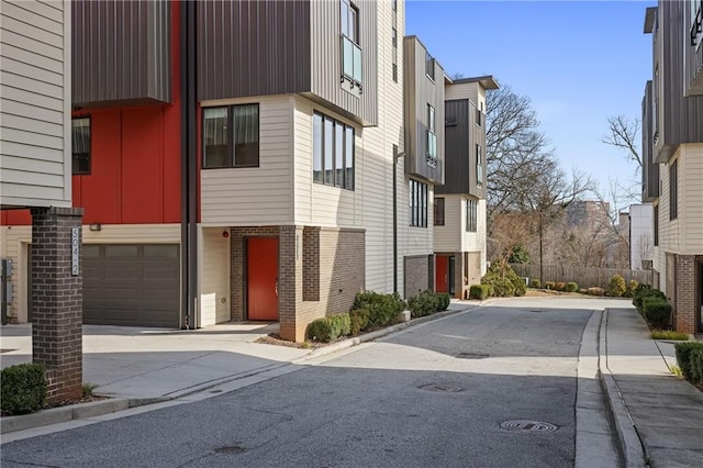 view of property with a residential view and driveway