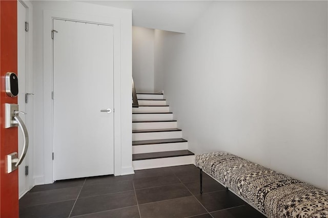 stairway with tile patterned flooring