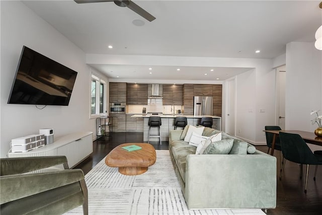 living room featuring a ceiling fan, recessed lighting, and dark wood-style floors