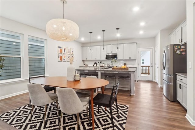 dining space featuring wood-type flooring