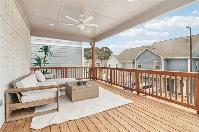 deck with outdoor lounge area and ceiling fan