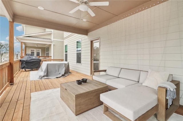 wooden terrace with ceiling fan, an outdoor hangout area, and area for grilling