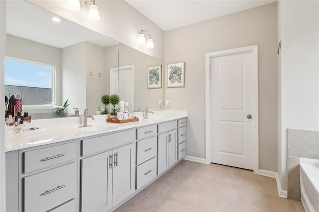 bathroom featuring vanity, a bathtub, and tile patterned floors