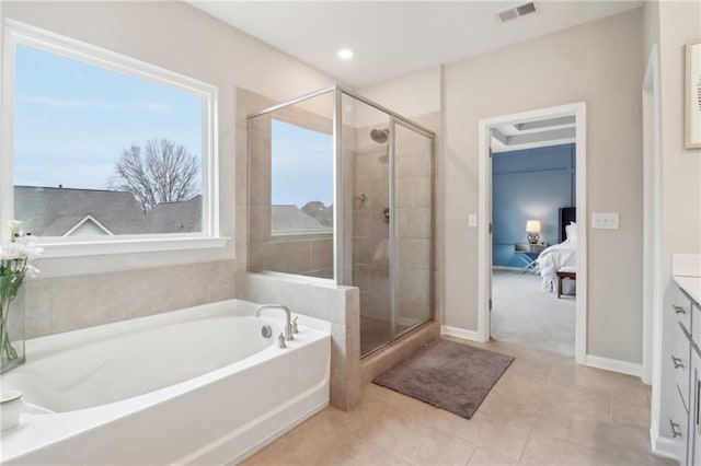 bathroom with vanity, tile patterned floors, and plus walk in shower