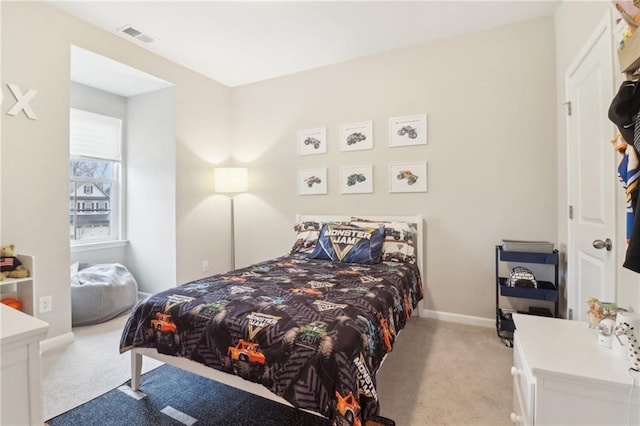 bedroom featuring light carpet