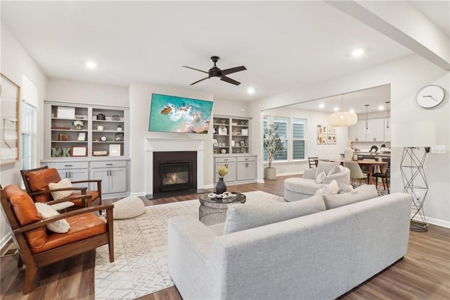 living room featuring wood-type flooring and ceiling fan