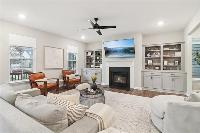 living room featuring hardwood / wood-style floors and ceiling fan