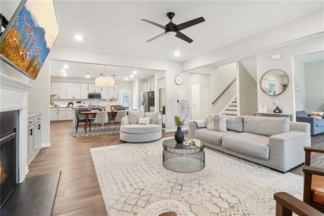 living room with ceiling fan and wood-type flooring