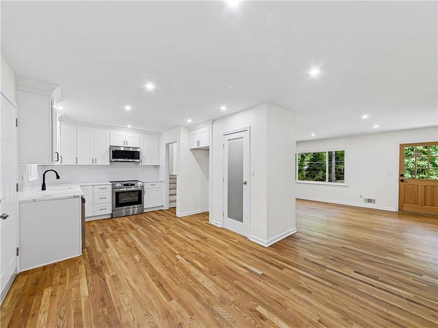 466 Thackery Pl SW, Atlanta, GA 30311 - kitchen with stainless steel appliances, open floor plan, light countertops, healthy amount of natural light, and recessed lighting