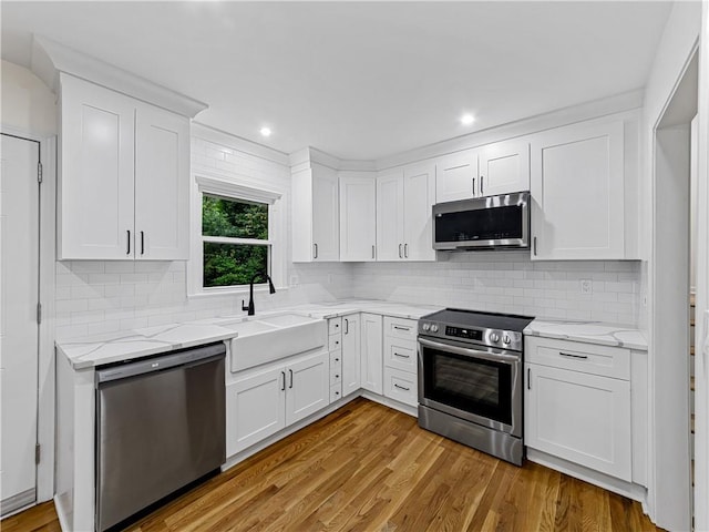 466 Thackery Pl SW, Atlanta, GA 30311 - kitchen with stainless steel appliances, a sink, white cabinets, and recessed lighting