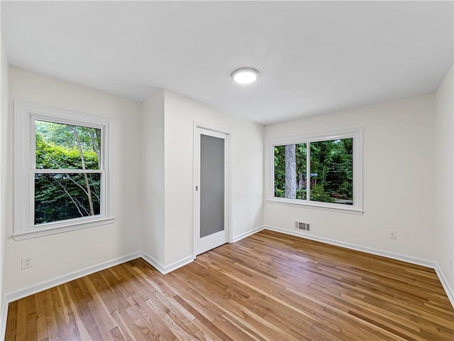 466 Thackery Pl SW, Atlanta, GA 30311 - unfurnished bedroom with multiple windows, light wood finished floors, and baseboards