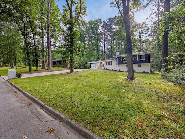 466 Thackery Pl SW, Atlanta, GA 30311 - view of front of house with concrete driveway, a front lawn, a chimney, view of wooded area, and an attached garage