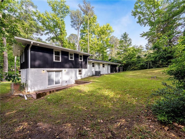 466 Thackery Pl SW, Atlanta, GA 30311 - back of house with board and batten siding, a lawn, and brick siding